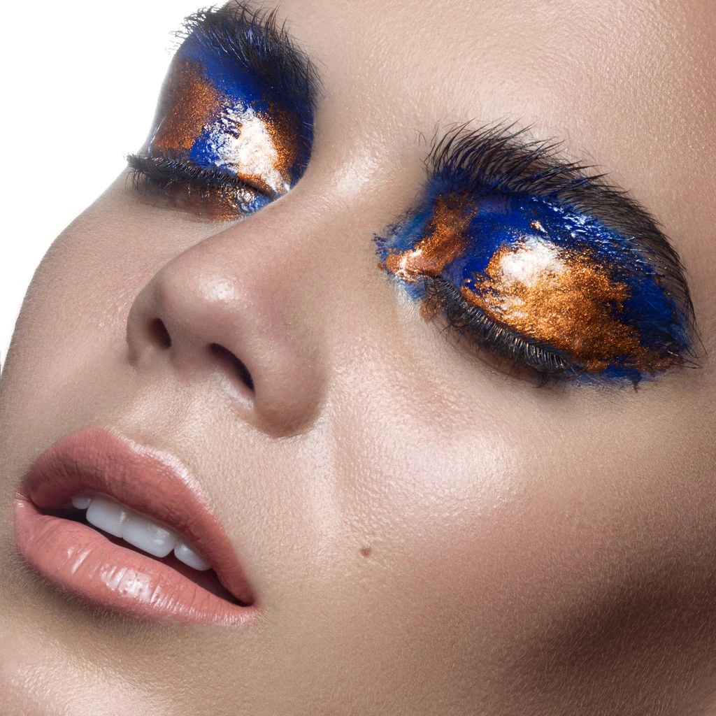 Close-up of dewy apricot blush on cheekbone.